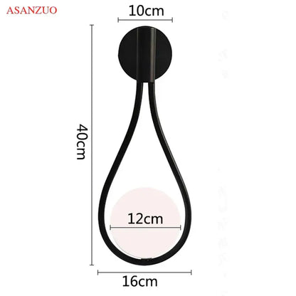 Black teardrop-shaped wall lamp with metallic finish complements decorbites glass ball brass pendant light for nordic decor