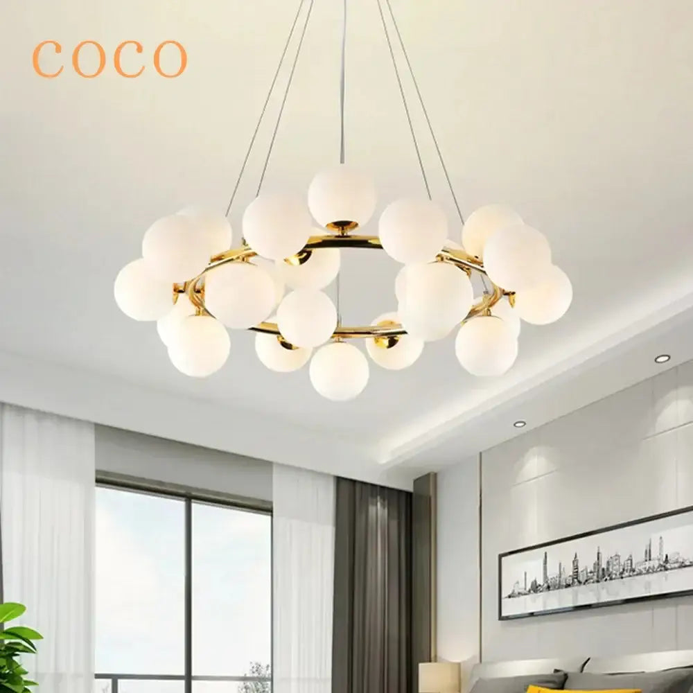 Gold-toned decorbites glass ball ceiling chandelier with frosted white spherical globes for dining and living room decor