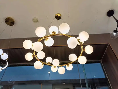 Gold-toned DecorBites glass ball ceiling chandelier with frosted glass globe bulbs for dining and living room decor
