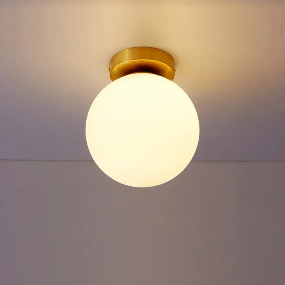 Decorbites glass ball ceiling light fixture with a warm glowing glass globe and brass-finished mounting base for bedrooms