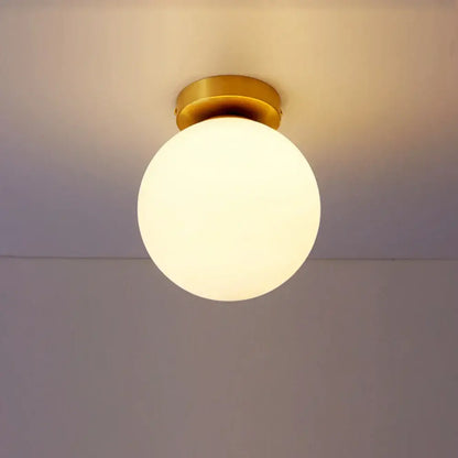 Decorbites glass ball ceiling light fixture with a warm glowing glass globe and brass-finished mounting base for bedrooms