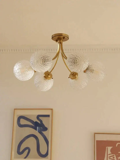 Brass-finished decorbites glass ball ceiling light with five clear textured glass globe shades for modern interiors