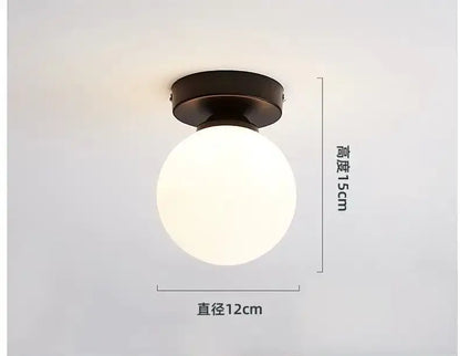 A sleek decorbites glass ball ceiling light with frosted white glass globe and antique bronze metal base for modern decor