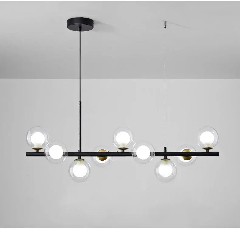 Black metal DecorBites™ glass ball chandelier with clear glass globe bulbs and gold-toned accents for home lighting