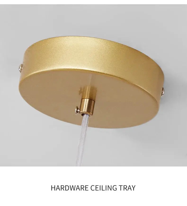 Gold-colored circular ceiling tray with brushed metallic finish and central mounting hardware for glass ball chandelier