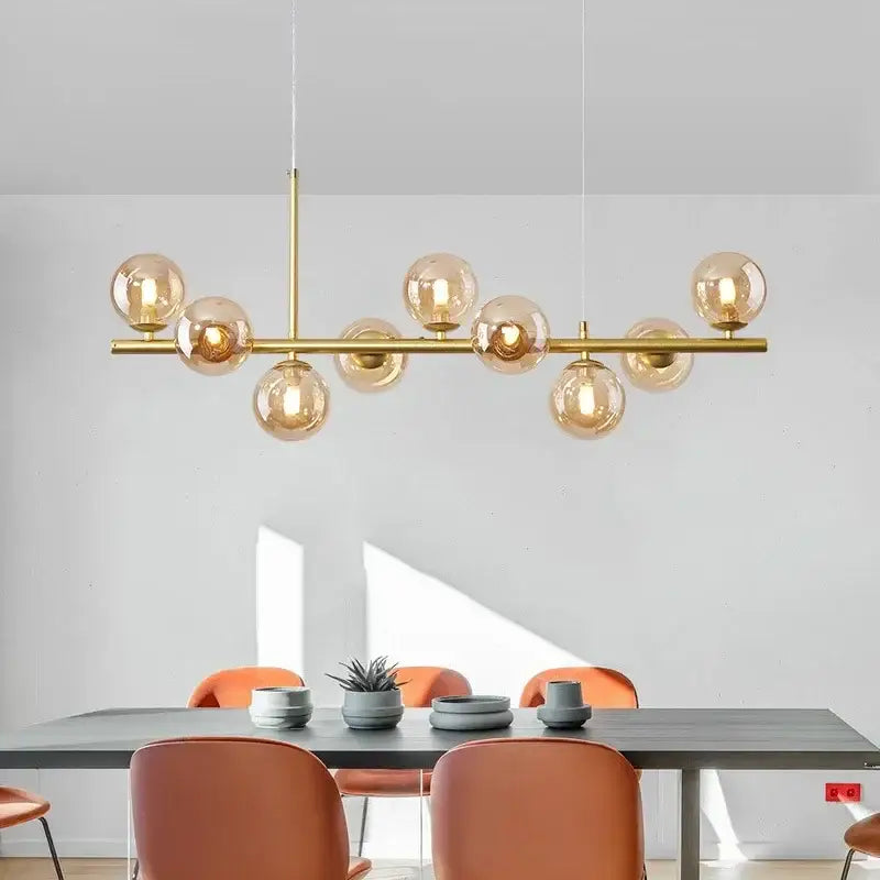 Gold-toned DecorBites™ glass ball chandelier with amber glass globe bulbs arranged on a horizontal bar for home lighting
