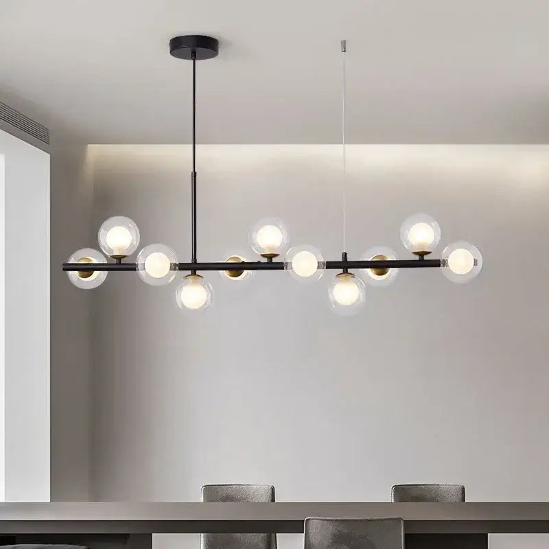 Modern black metal DecorBites™ glass ball chandelier with clear glass globe bulbs and gold-toned accents for home lighting