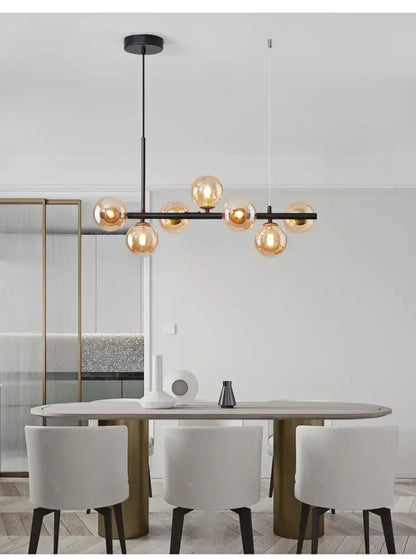 Modern black metal DecorBites glass ball chandelier featuring warm amber glass globe bulbs for home lighting
