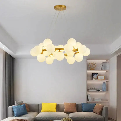Gold-toned decorbites glass ball chandelier with frosted glass globes for modern living room and kitchen island lighting