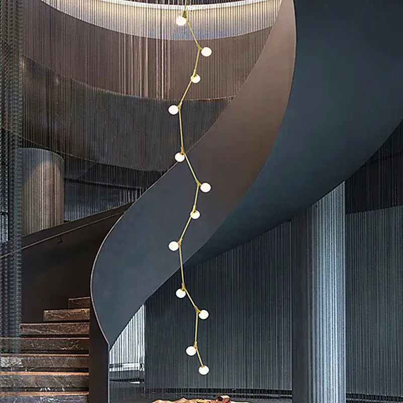A modern gold-toned decorbites glass ball chandelier with branching design and white spherical bulbs for villa decor