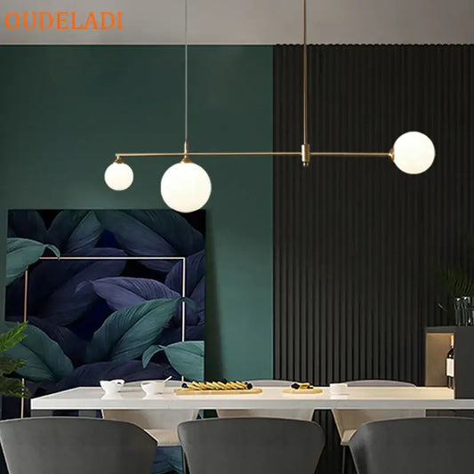 Modern brass pendant light fixture with three frosted glass globe bulbs by DecorBites glass ball for dining room use