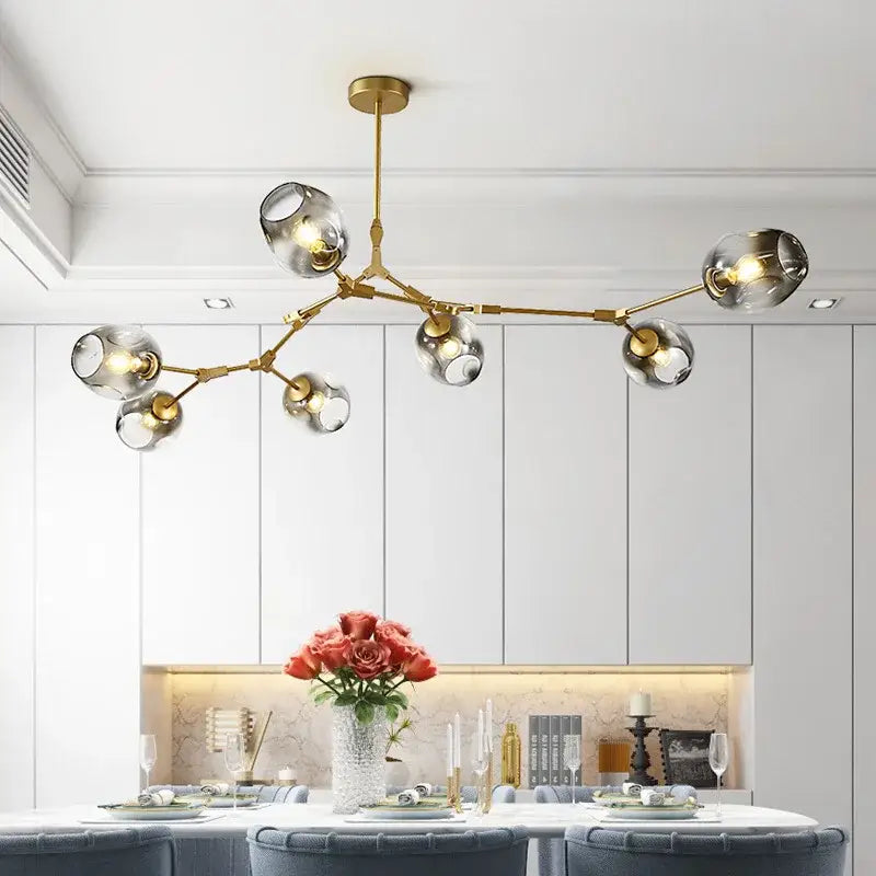 Gold-toned DecorBites glass ball led chandelier with clear glass globe shades in modern nordic style lighting design