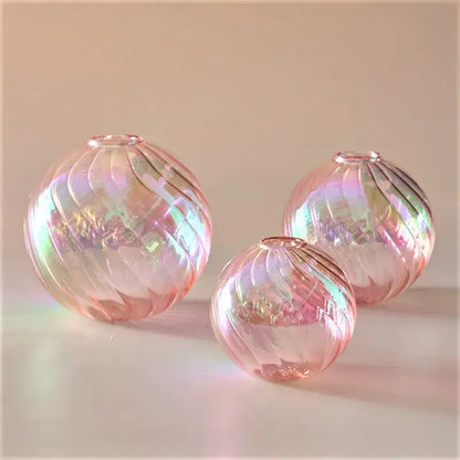 Set of three iridescent pink glass ball vases with swirling ribbed patterns for elegant home decor vase set