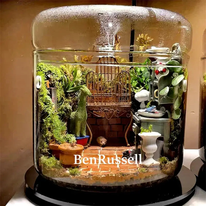 Decorbites™ glass bottle terrarium kit featuring a whimsical micro landscape glass with moss, figurines, and ceramic pots