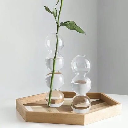 Decorbites glass bubble hydroponic vase made of clear glass with stacked spheres holding a single green rose stem