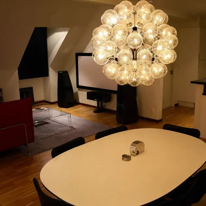 A modern decorbites glass bubble kitchen chandelier with clear glass bulbs clustered in a spherical design for dining rooms