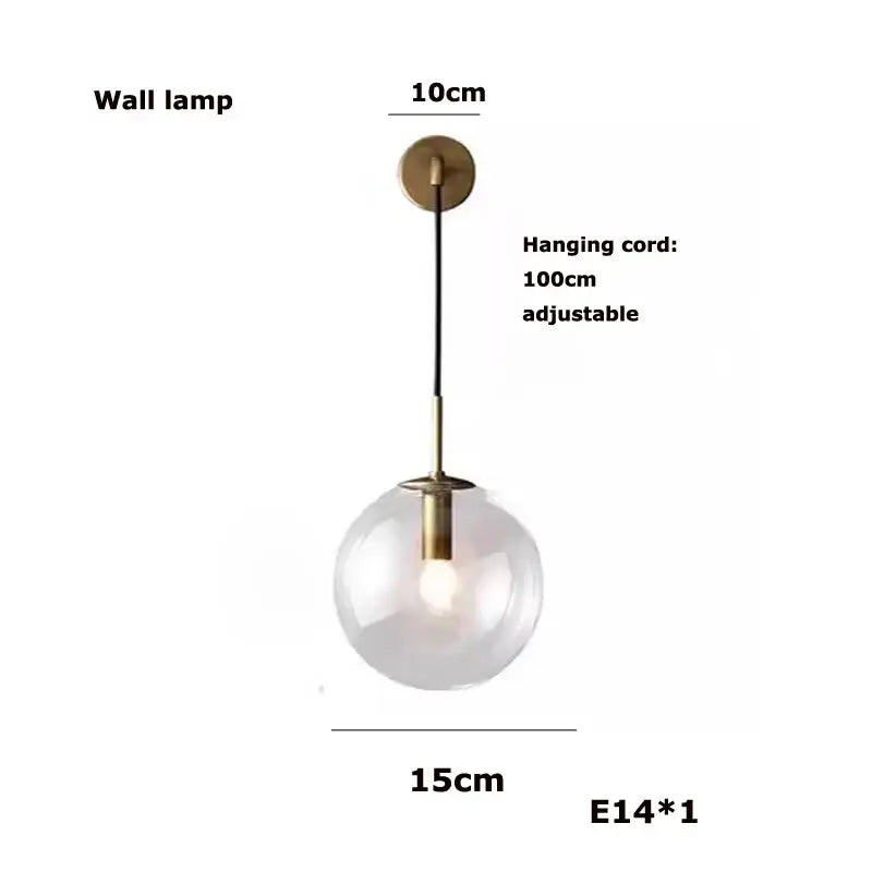 A modern decorbites glass bubble kitchen island chandelier with clear glass globe and brass finish on black cord