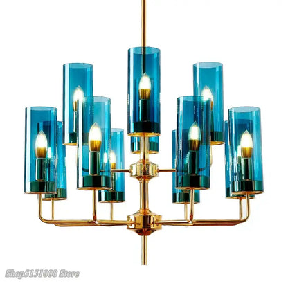 Decorbites glass chandelier featuring blue glass cylinder and brass accents with multiple lit bulbs for luxury dining room lighting