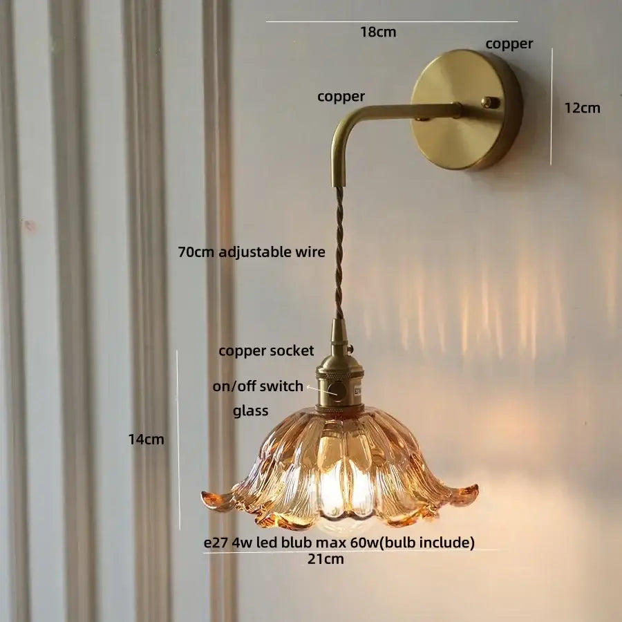 A warm amber glass copper green flower led wall sconce with fluted design and copper-finished metal by DecorBites