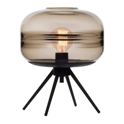 A sleek smoked glass metal nordic sofa desk lamp with tripod base and exposed filament bulb for bedroom use