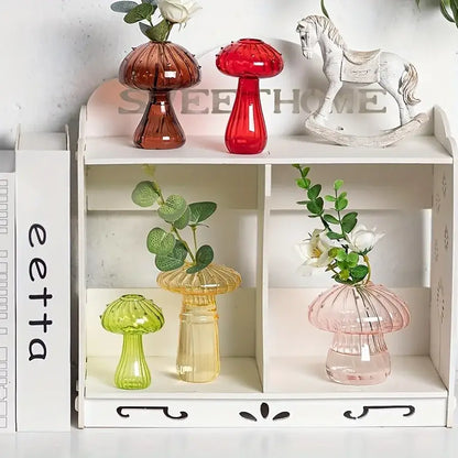 Set of four colorful glass mushroom hydroponic planters in red amber green and pink for home and garden decor