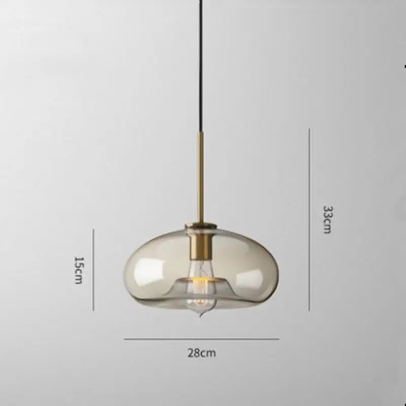 DecorBites™ glass pendant lights with translucent amber glass shade and brass accents suspended by black cord