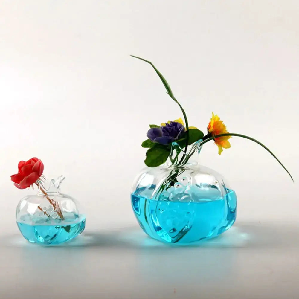 DecorBites™ home decor glass vase shaped like a pomegranate with vibrant blue water and a single artificial flower