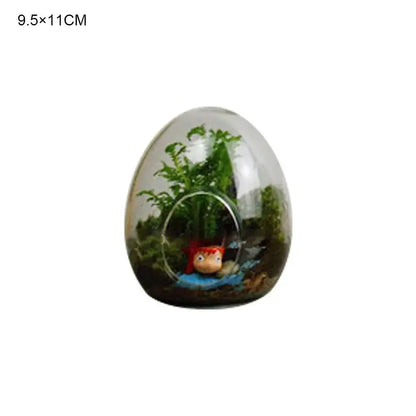High quality glass egg-shaped terrarium with green plants and red accessory figurine by DecorBites™