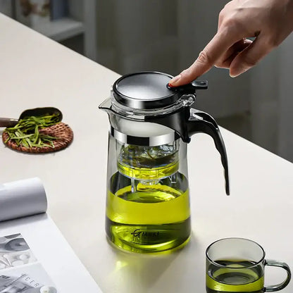 DecorBites glass tea pot with infuser features clear glass, black handle, stainless steel lid, and internal strainer for steeping