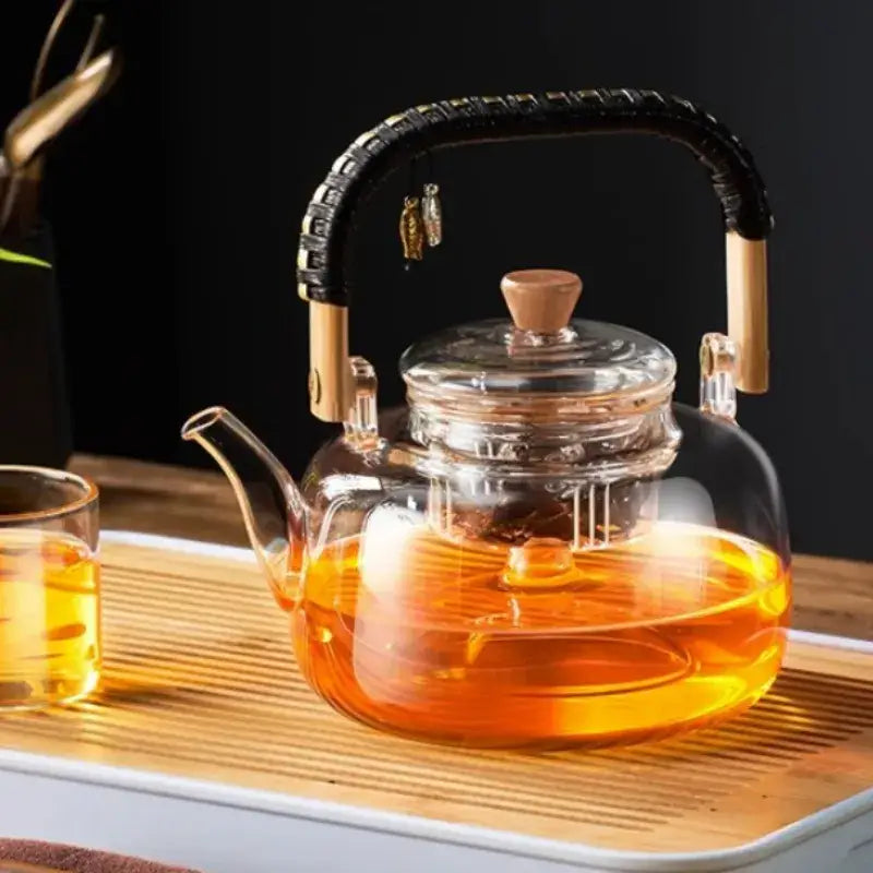 DecorBites glass tea pot with transparent heat-resistant glass, black weave handle, wooden accents, and bamboo lid knob