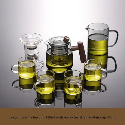 Decorbites glass tea set with clear glass teapot filled with green tea and solid wood handle and lid