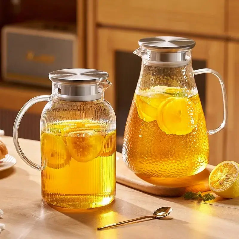 Decorbites glass tea set with clear textured glass pitchers and stainless steel lids filled with lemon-infused tea
