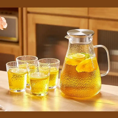 Clear textured glass pitcher filled with lemon tea in decorbites glass tea set with stainless steel lid and handle