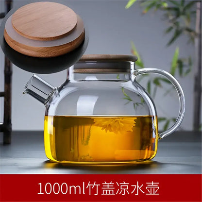 Clear glass teapot with wooden lid and handle filled with golden tea decorbites glass teapot cold jug 1000ml