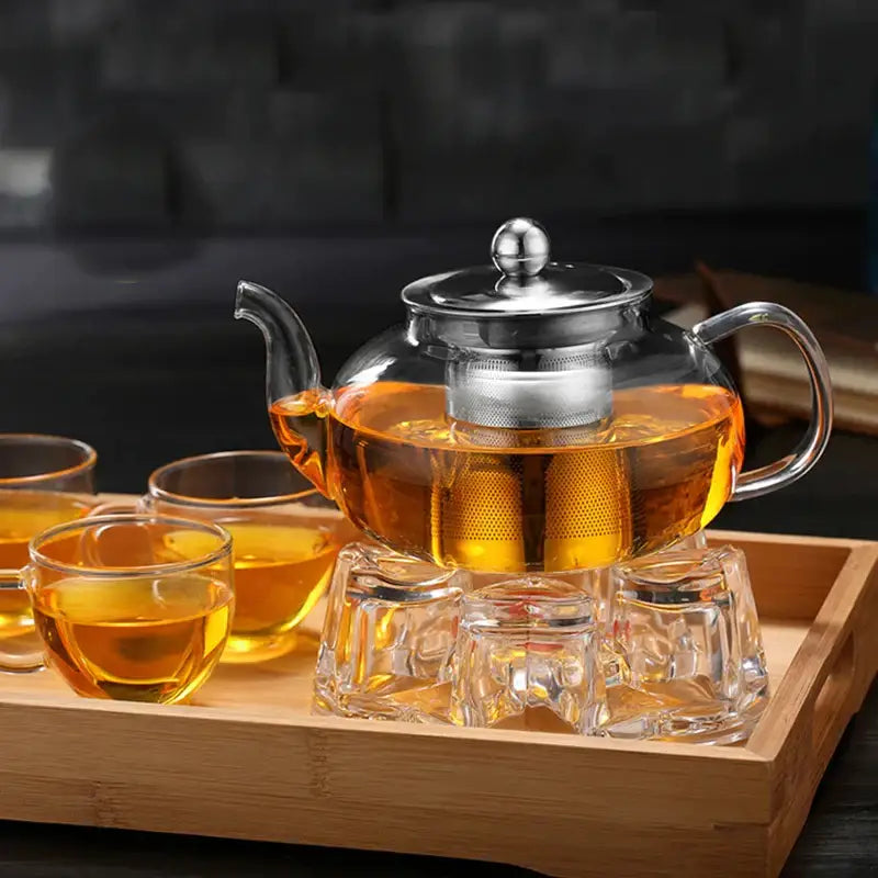 Clear glass decorbites glass teapot with stainless steel lid and built-in filter filled with amber tea for flower tea set