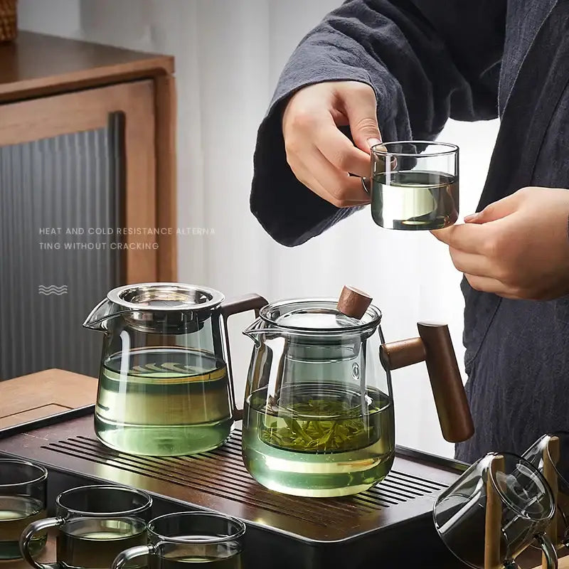 Clear glass teapot with wooden handle and lid knob featuring heat and cold resistance by DecorBites glass teapot