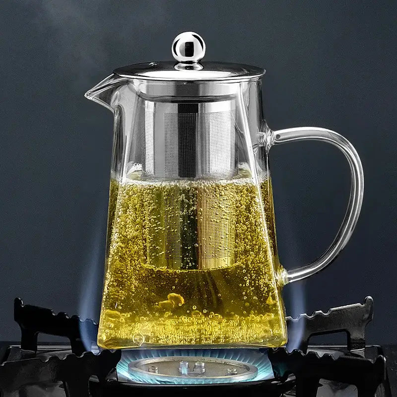 Clear glass decorbites glass teapot with stainless steel lid and built-in filter filled with steaming golden tea for kungfu tea set