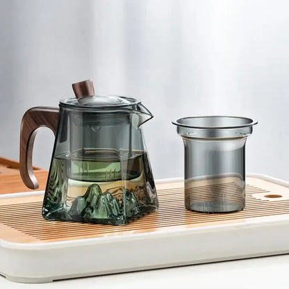 Transparent decorbites glass teapot with wooden handle and lid featuring mountain landscape inside for kung fu tea brewing