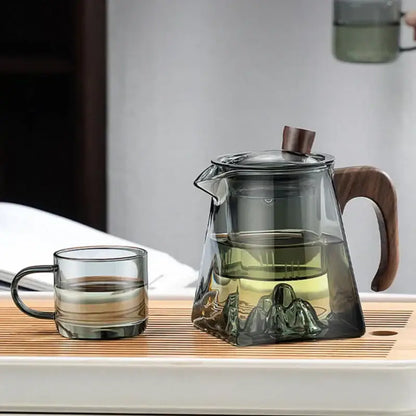 Decorbites glass teapot with wooden handle and lid knob featuring transparent heat resistant glass and embossed mountain design