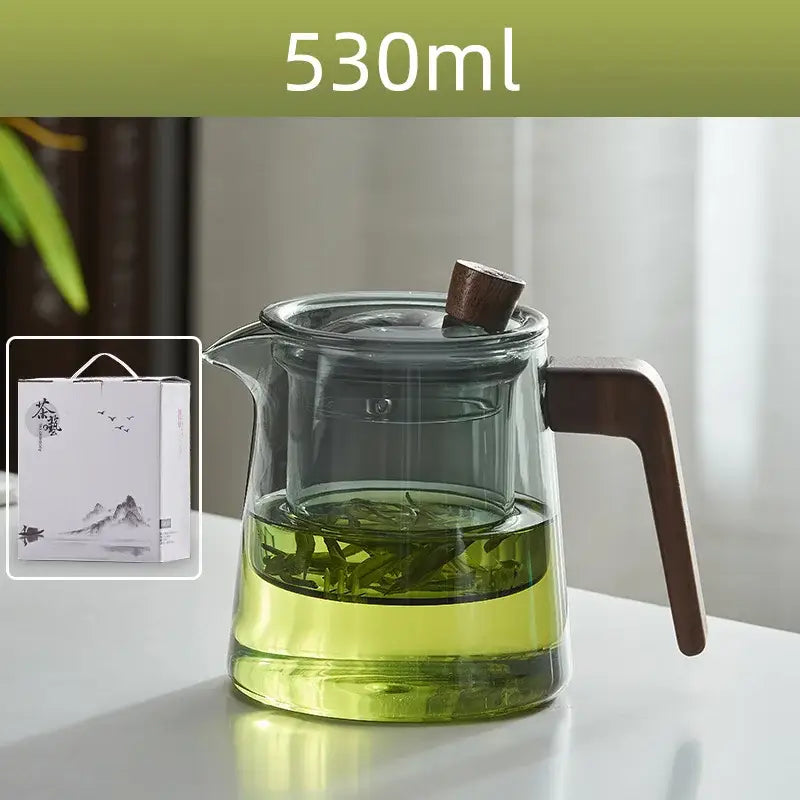 530ml decorbites glass teapot with wood handle and knob filled with green tea leaves steeping in clear liquid