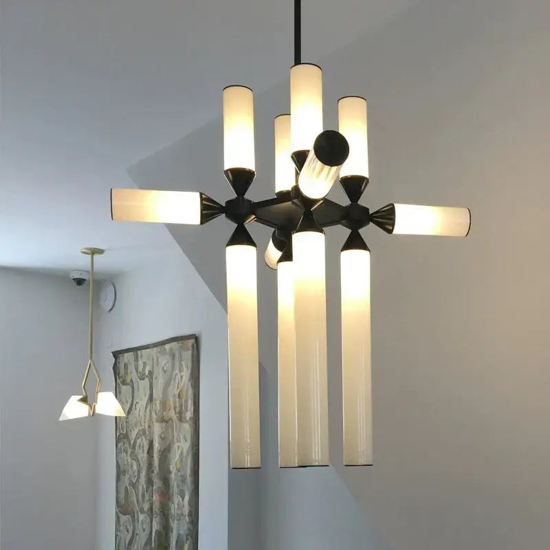 Modern decorbites glass tube chandelier pendant lamp with black metal frame and frosted glass tubes emitting warm light