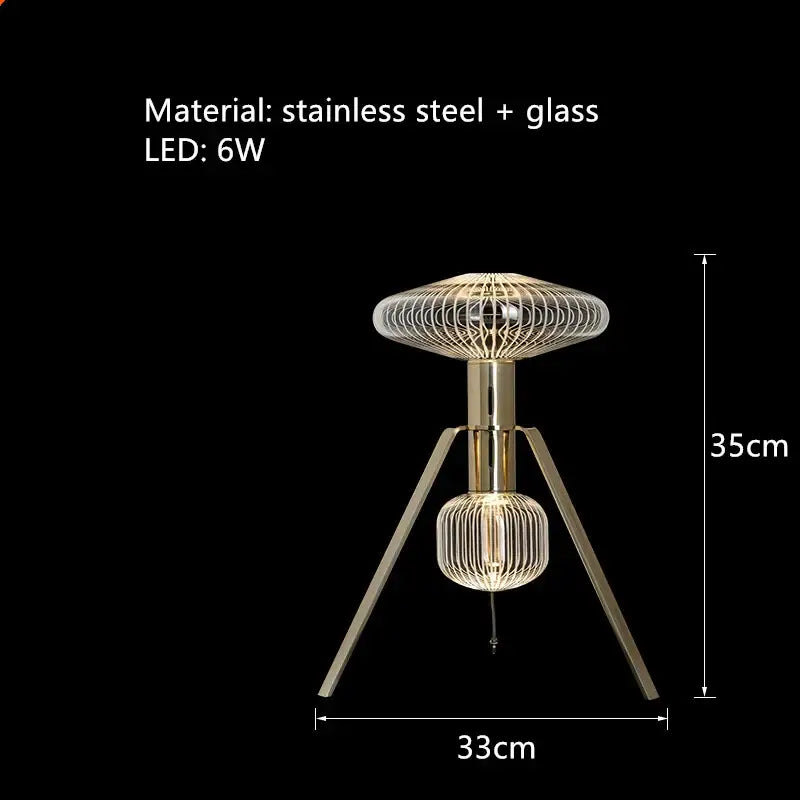 Modern tripod table lamp with gold stainless steel frame and glass shades featuring wire mesh design by decorbites glass tubes