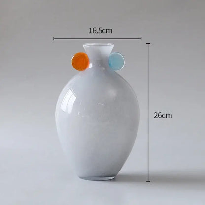 A sleek glossy white glass vase by decorbites glass featuring colorful orange and light blue spherical handles for decor