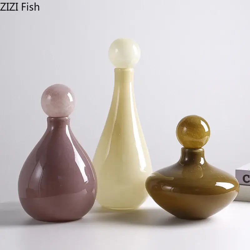 Three glossy ceramic decorative bottles with spherical stoppers in muted mauve creamy yellow and amber for decorbites glass vase flower arrangement