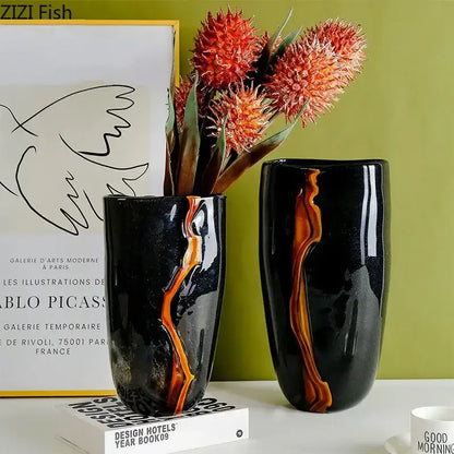Two sleek black ceramic decorbites glass vases with glossy finish and orange gold marbled streak for modern home decor
