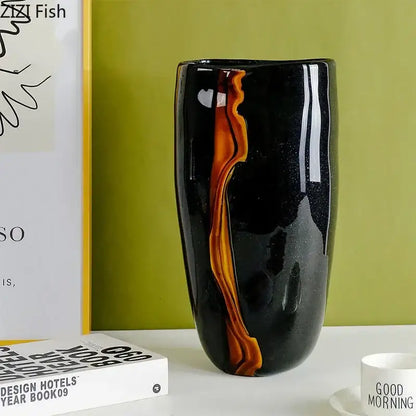 A sleek black glass vase with amber orange swirls by DecorBites glass vase for modern home decor and hydroponics