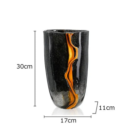 A tall sleek black decorbites glass vase with vibrant orange swirl and silver speckles for modern home decor