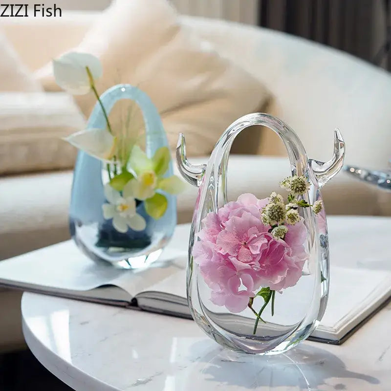 Clear glass DecorBites glass vase terrarium with handle and horn-like protrusions holding pink hydrangeas