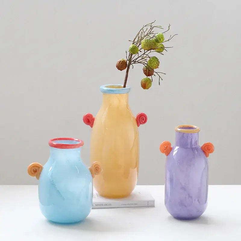 Three colorful translucent decorbites glass vases with whimsical spiral candy handles for home decor and floral arrangements
