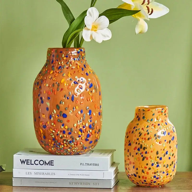 A vibrant terracotta decorbites glass vase with a speckled multicolored glaze ideal for home decor and hydroponic plants